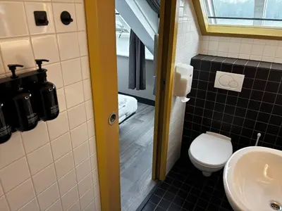 a bathroom with a toilet and a sink at Hotel Oostereiland in Hoorn