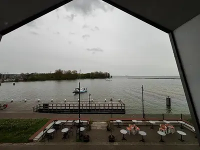 a view of a body of water with a dock and a boat at Hotel Oostereiland in Hoorn