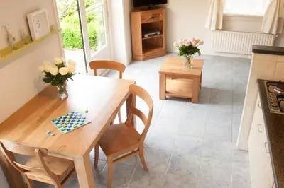 a kitchen and dining room with a table and chairs at Sint Nicolaashoeve in Nieuwveen