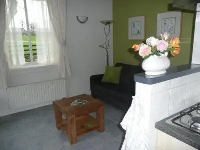 a living room with a vase of flowers on a fireplace at Sint Nicolaashoeve in Nieuwveen