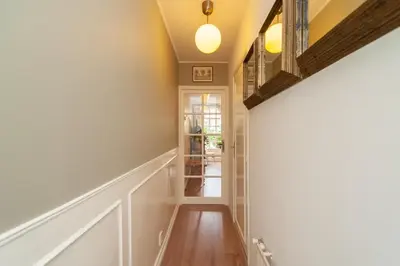 a hallway with white walls and wood floors at CASASdeCASPER - Studio Alkmaar in Alkmaar