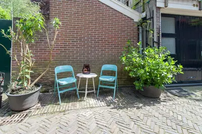two chairs and a table in front of a brick building at CASASdeCASPER - Studio Alkmaar in Alkmaar