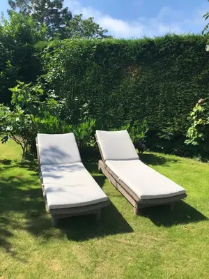 two beds sitting on the grass in a yard at de Ark in Schoorl