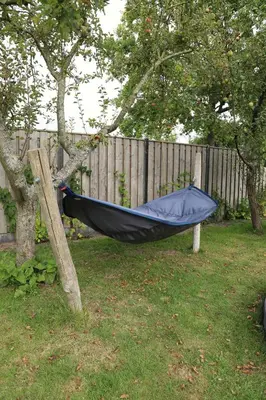 a hammock hanging from a tree in a yard at de Ark in Schoorl