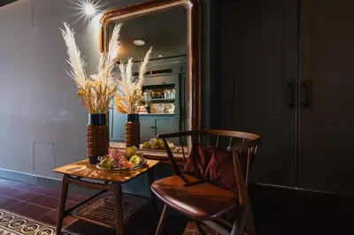 a dining room table with a chair and a mirror at Hotel Mercier in Amsterdam