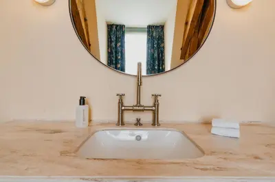 a bathroom with a sink and a mirror at Hotel Mercier in Amsterdam