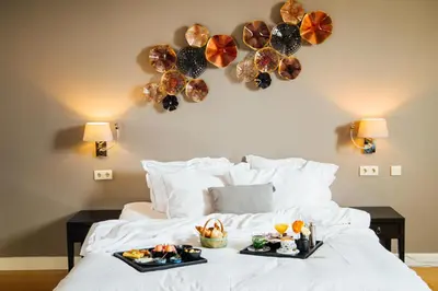 a bed with two trays of food on it at Hotel ML in Haarlem