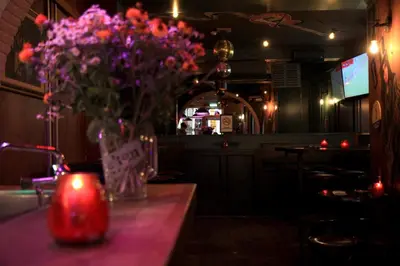 a vase of flowers sitting on a table with a candle at Hotel 55 - City Centre in Amsterdam