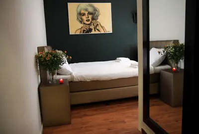 a room with a bed and a mirror at Hotel 55 - City Centre in Amsterdam