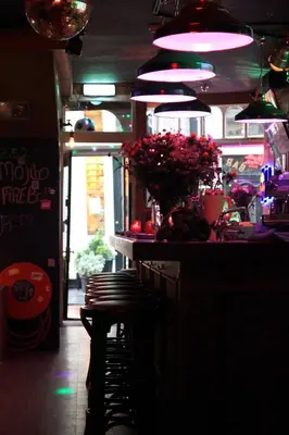 a bar with a row of chairs in a restaurant at Hotel 55 - City Centre in Amsterdam