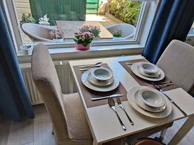 a table and chairs with plates and utensils on it at Yuki in Zandvoort