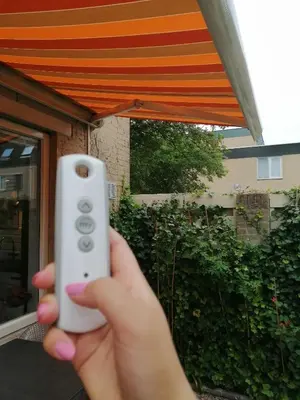 a person holding a remote control in front of a house at Yuki in Zandvoort