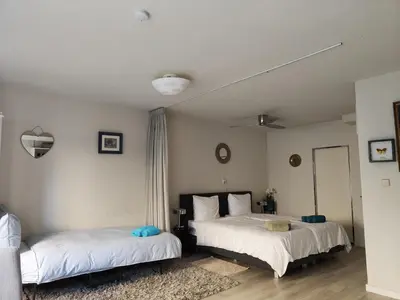 a bedroom with two beds and a mirror at Yuki in Zandvoort