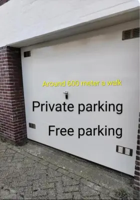 a garage door with a sign that reads parachute parking free parking at Yuki in Zandvoort