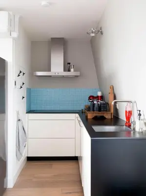 a kitchen with a black and white counter top at BB Museumquarter in Amsterdam