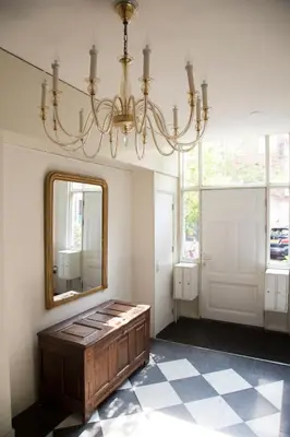 a mirror and a chandelier in a room at BB Museumquarter in Amsterdam