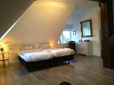 a bedroom with a bed in a room at Shepherds House B&B in Limmen