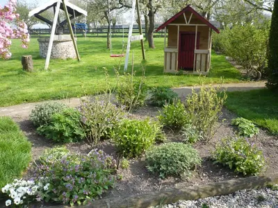 a garden with a dog house and some flowers at Shepherds House B&B in Limmen