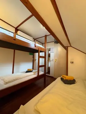 two bunk beds are in a room with at Hotelboot Zwaan in Amsterdam