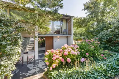 a house with flowers in front of it at Beach House Amsterdam Lohman in Zandvoort