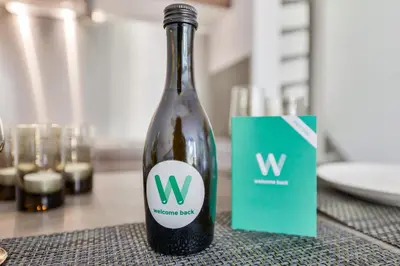 a bottle of wine sitting on top of a table at Beach House Amsterdam Lohman in Zandvoort