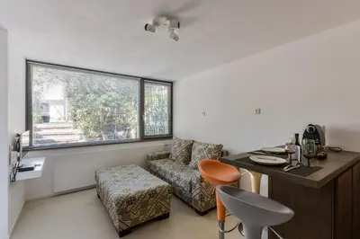 a room with a desk and a chair and a window at Beach House Amsterdam Lohman in Zandvoort