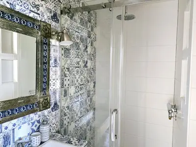 a bathroom with a shower and a sink at CASA KAREN - Houseboat studio with private terrace in Amsterdam