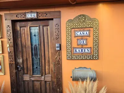 a door and a sign on the side of a house at CASA KAREN - Houseboat studio with private terrace in Amsterdam