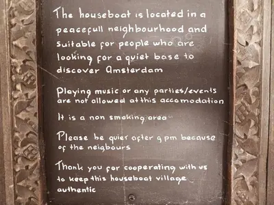 a sign on a wall with a poem on it at CASA KAREN - Houseboat studio with private terrace in Amsterdam