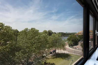 a window with a view of a river and trees at 2L De Blend in Utrecht