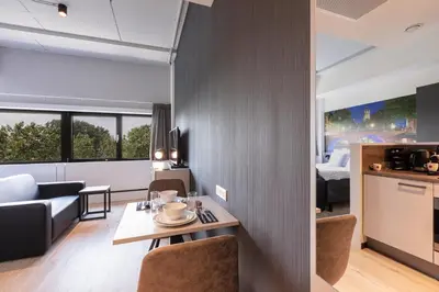 a kitchen and living room with a table and chairs at 2L De Blend in Utrecht
