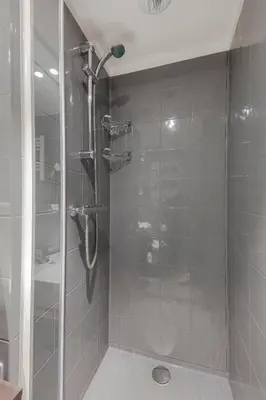 a shower with a glass door in a bathroom at 2L De Blend in Utrecht