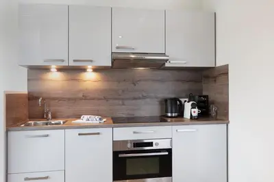 a kitchen with white cabinets and a sink at 2L De Blend in Utrecht
