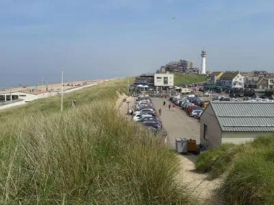 a bunch of cars parked in a parking lot at the beach at Joy in Egmond-Binnen