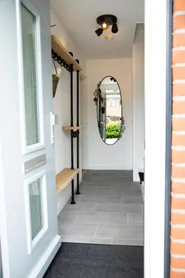 a hallway with a door and a mirror at Beautiful family house 5 min away from Amsterdam in Badhoevedorp
