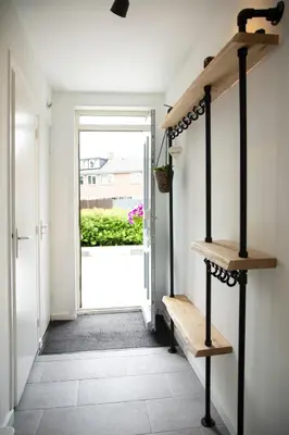 a hallway with a bench and an open door at Beautiful family house 5 min away from Amsterdam in Badhoevedorp