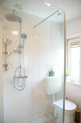 a bathroom with a shower and a toilet at Beautiful family house 5 min away from Amsterdam in Badhoevedorp