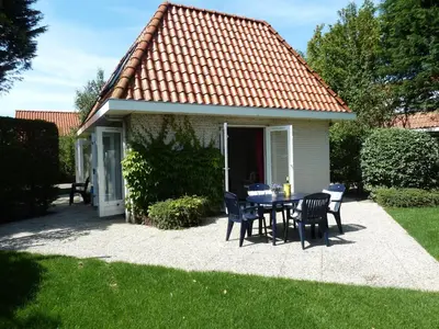 a table and chairs in front of a house at Noordwijk Holiday Rentals in Noordwijk