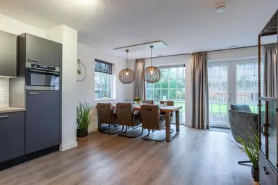 a kitchen and dining room with a table and chairs at Noordwijk Holiday Rentals in Noordwijk