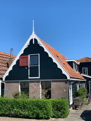 a black building with a red roof at Paleis Noordeinde in Grootschermer
