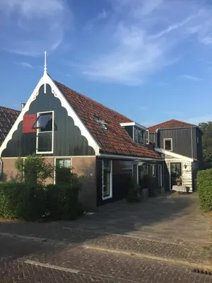 a large house with a gambrel roof at Paleis Noordeinde in Grootschermer