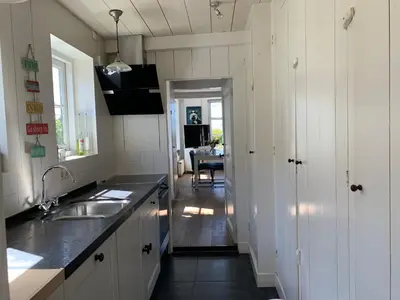 a kitchen with a sink and a counter top at Paleis Noordeinde in Grootschermer