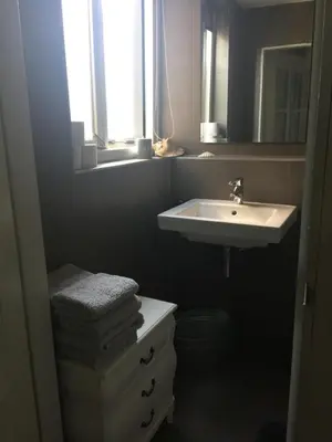 a bathroom with a sink and a toilet and a mirror at Paleis Noordeinde in Grootschermer