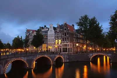 a bridge over a river in a city with buildings at Milkhouse Luxury Stay Amsterdam in Amsterdam