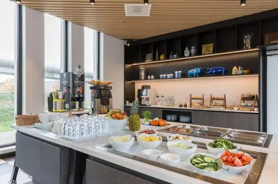 a buffet with fruits and vegetables on a counter at Postillion Hotel Amsterdam in Amsterdam