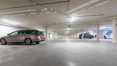 a parking garage with a van parked in it at Postillion Hotel Amsterdam in Amsterdam