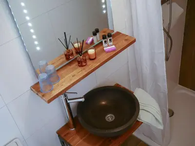 a bathroom with a black sink and a mirror at Hotel / Pension Villa Tanahlot in Zandvoort