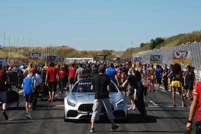 a crowd of people walking next to a race car at Hotel / Pension Villa Tanahlot in Zandvoort