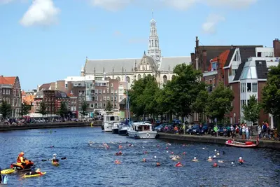 a group of people kayaking down a river in a city at Hotel / Pension Villa Tanahlot in Zandvoort