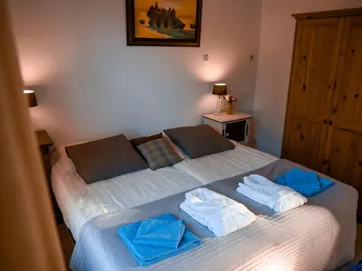 a bedroom with a bed with two towels on it at Hotel / Pension Villa Tanahlot in Zandvoort